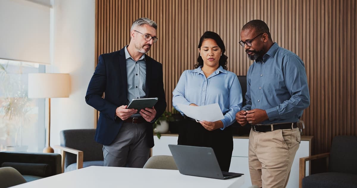 team reviewing documents tablet
