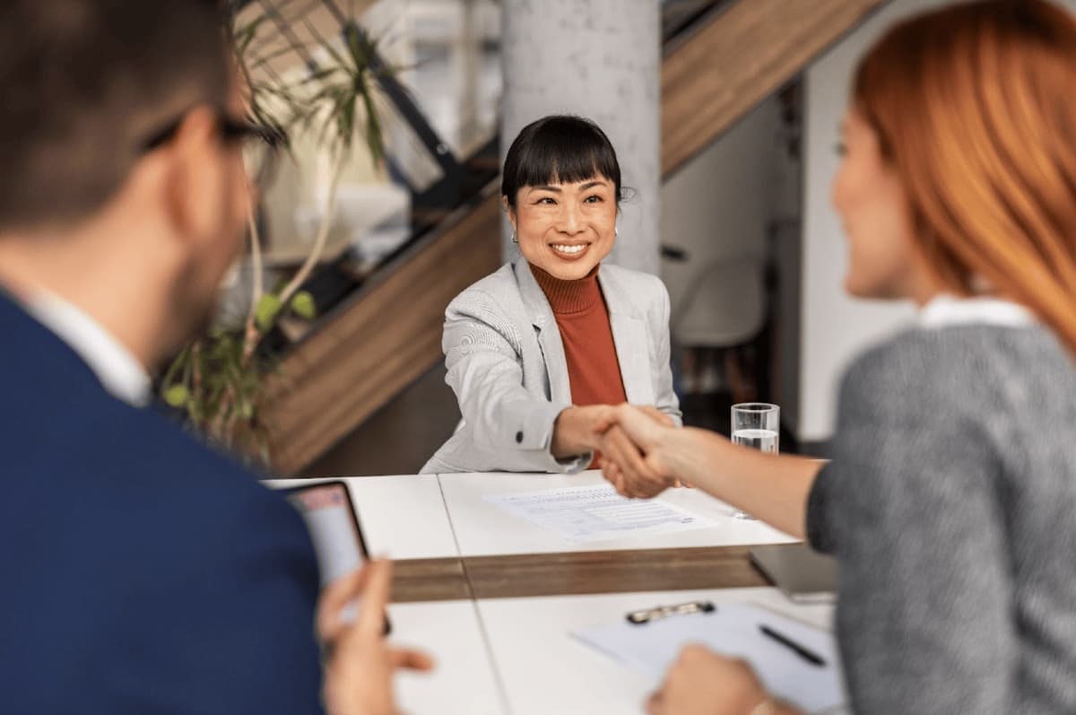 body consultant smiling shaking hand